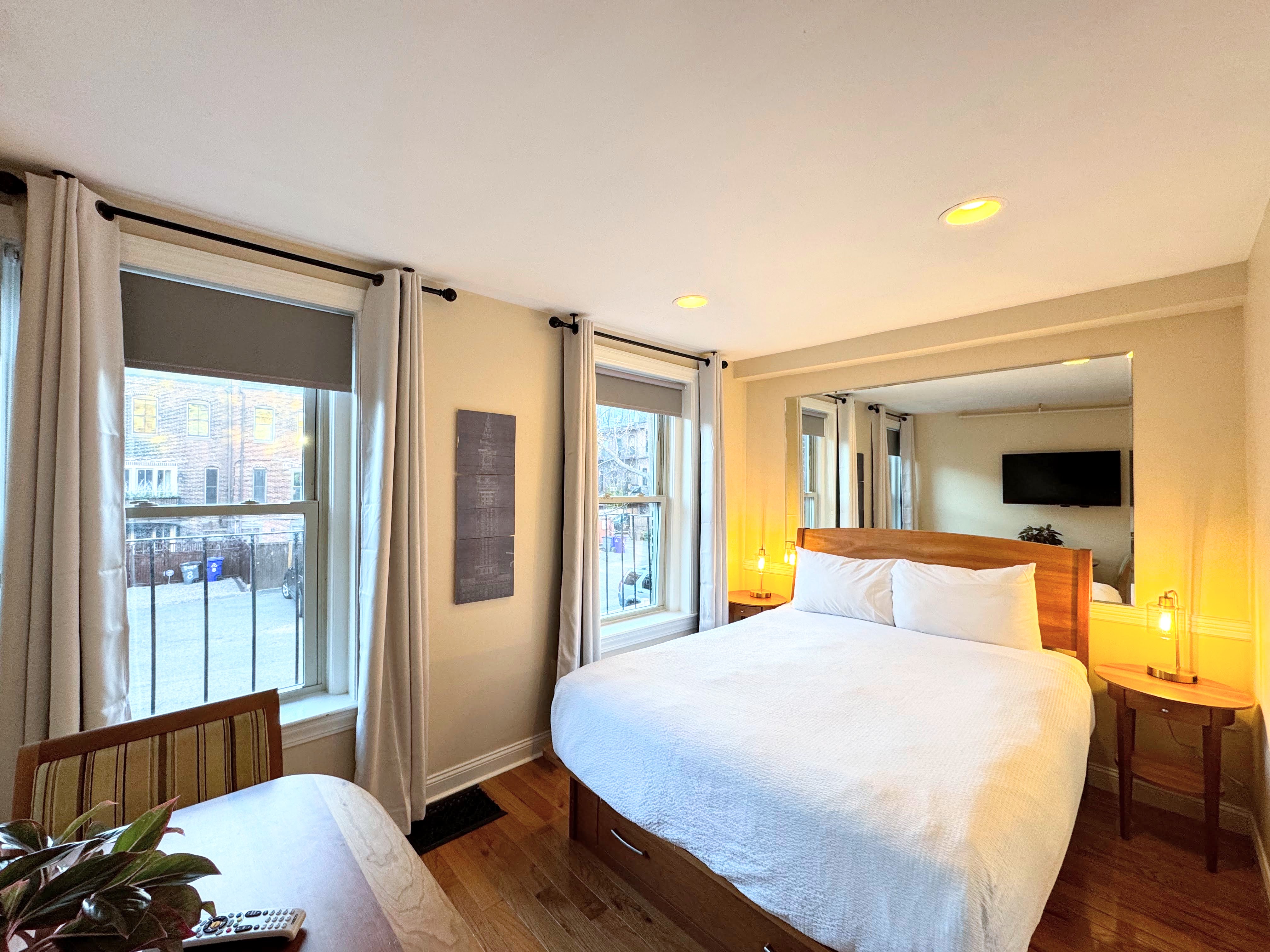 queen bed with back facing windows