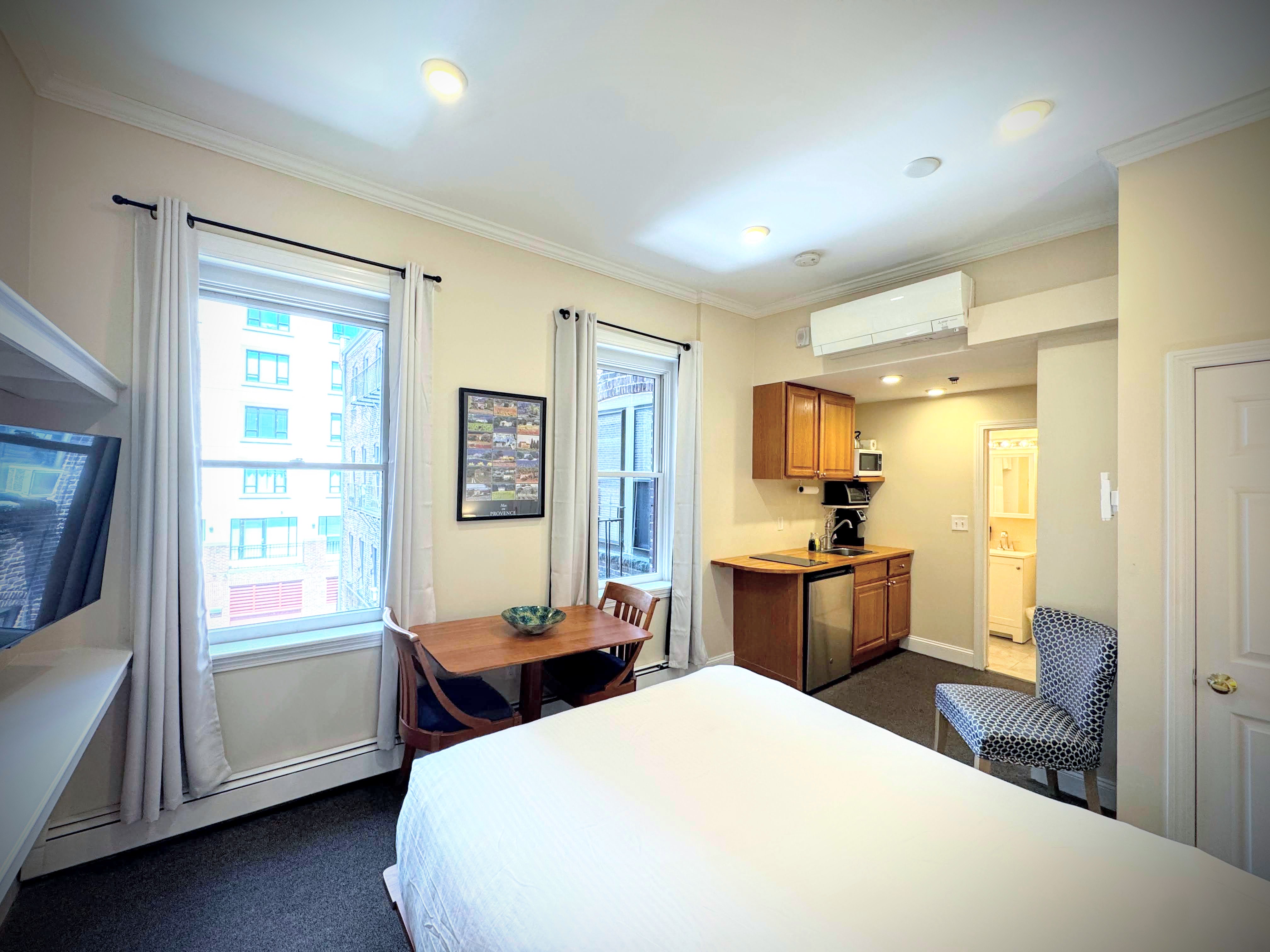 queen bed with back facing windows